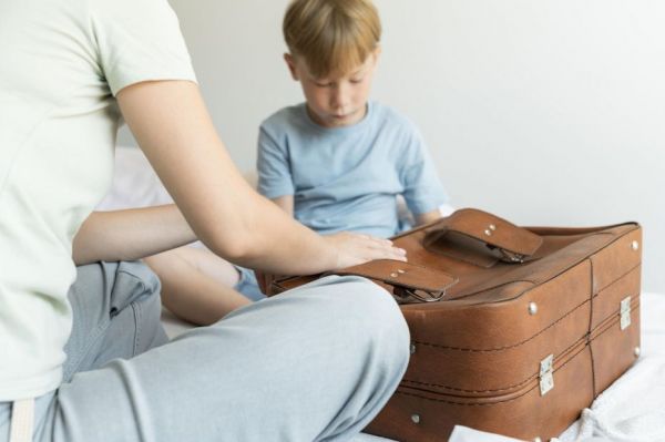 mother-son-preparing-suitcase-their-holiday