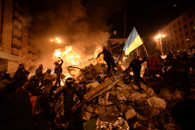 SState_flag_of_Ukraine_carried_by_a_protester_to_the_heart_of_developing_clashes_in_Kyiv,_Ukraine._Events_of_February_18,_2014